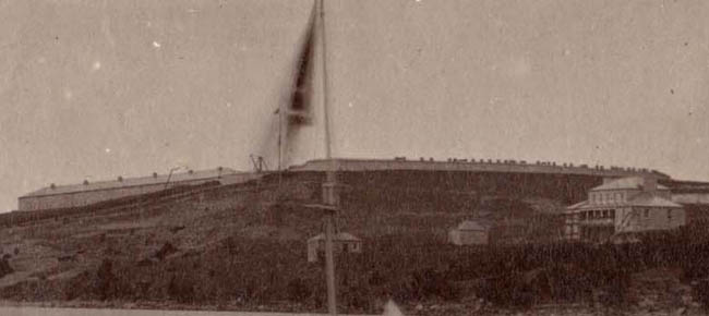 Close-up of a photo of the Garrison Hospital from Cedar Island ca. 1875 showing the Guard House and Deadhouse (Archives of ontario I0009575).